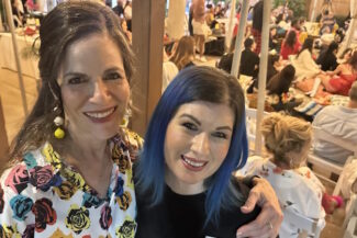 Professional makeup artist Diana at FABRIC’s 10th Anniversary fashion show in Tempe, Arizona, celebrating after creating 1950s runway looks.