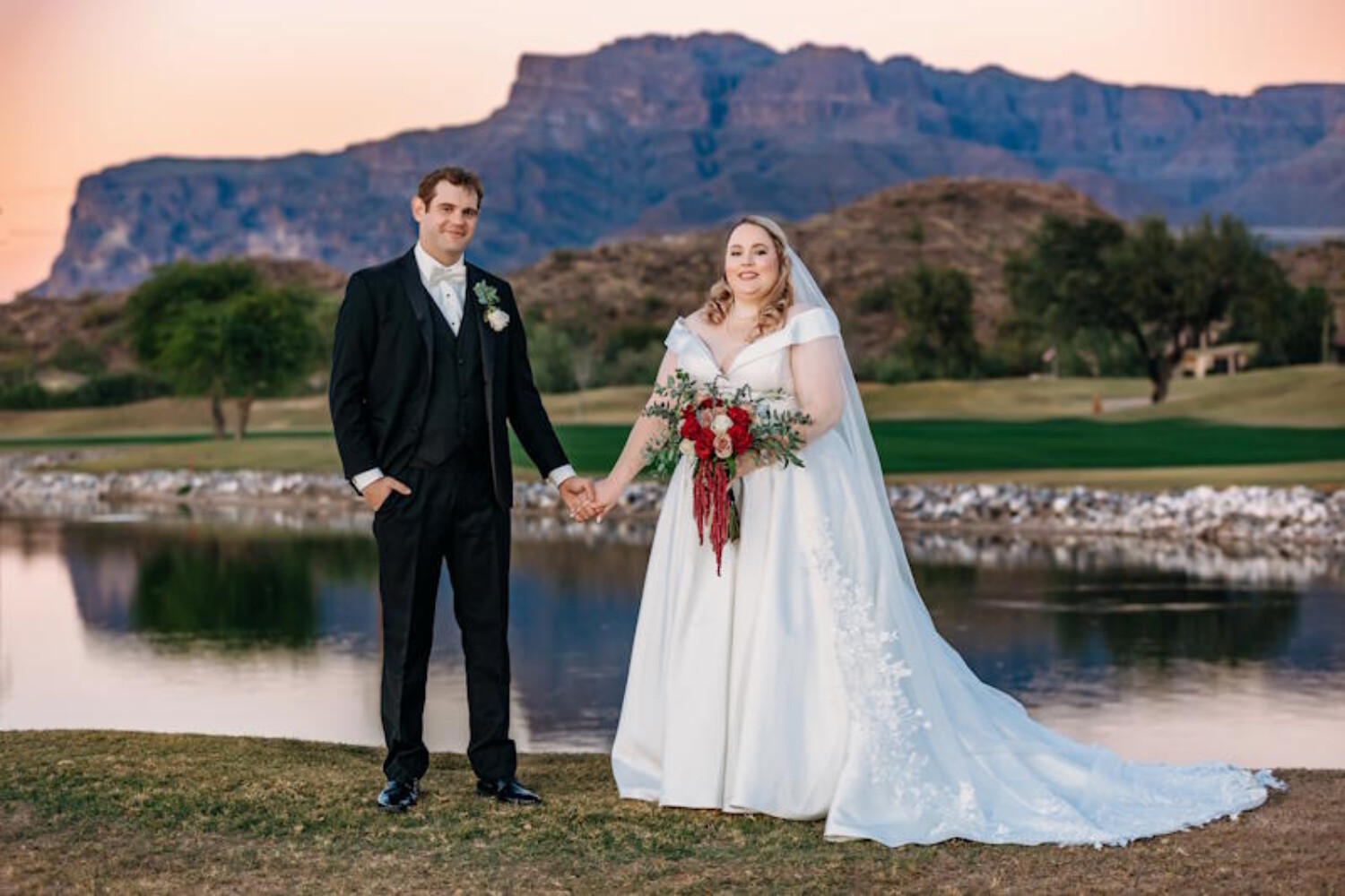 A bride and groom standing in front of the Superstition Mountains at The Views at Superstition, captured during an Arizona wedding with a stunning mountain backdrop.