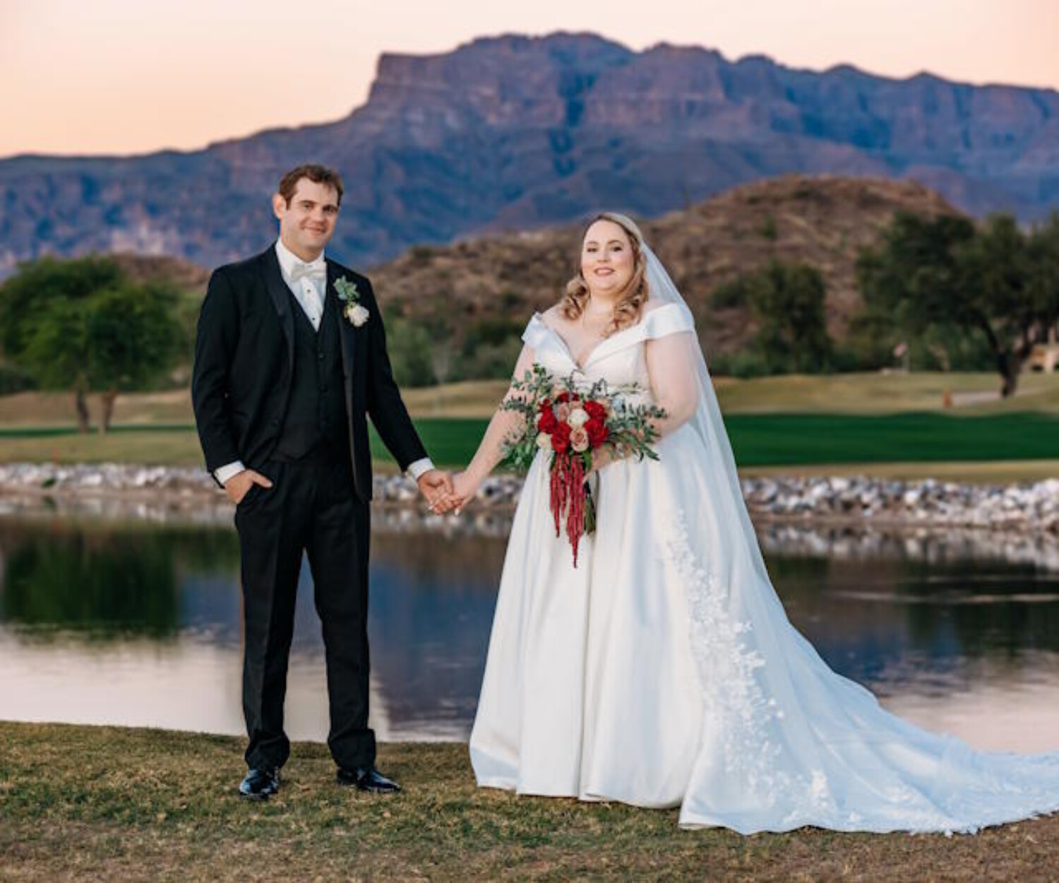 A bride and groom standing in front of the Superstition Mountains at The Views at Superstition, captured during an Arizona wedding with a stunning mountain backdrop.